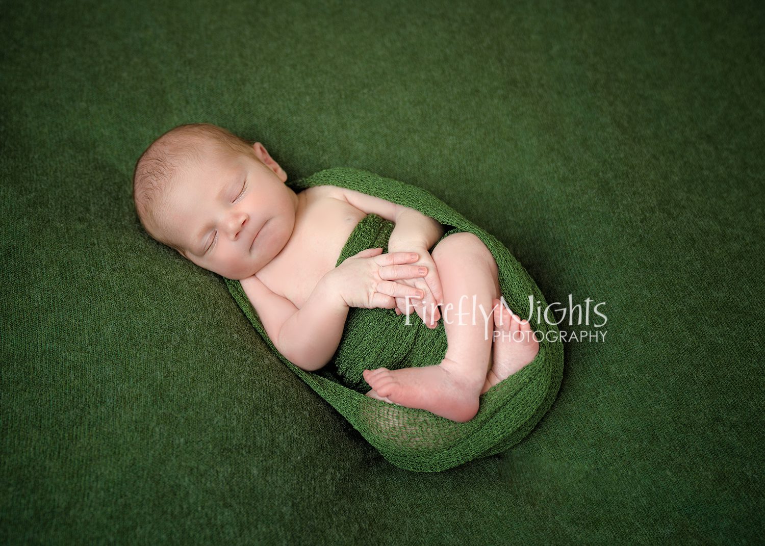 Newborn in sage green wrap Naperville baby photographer